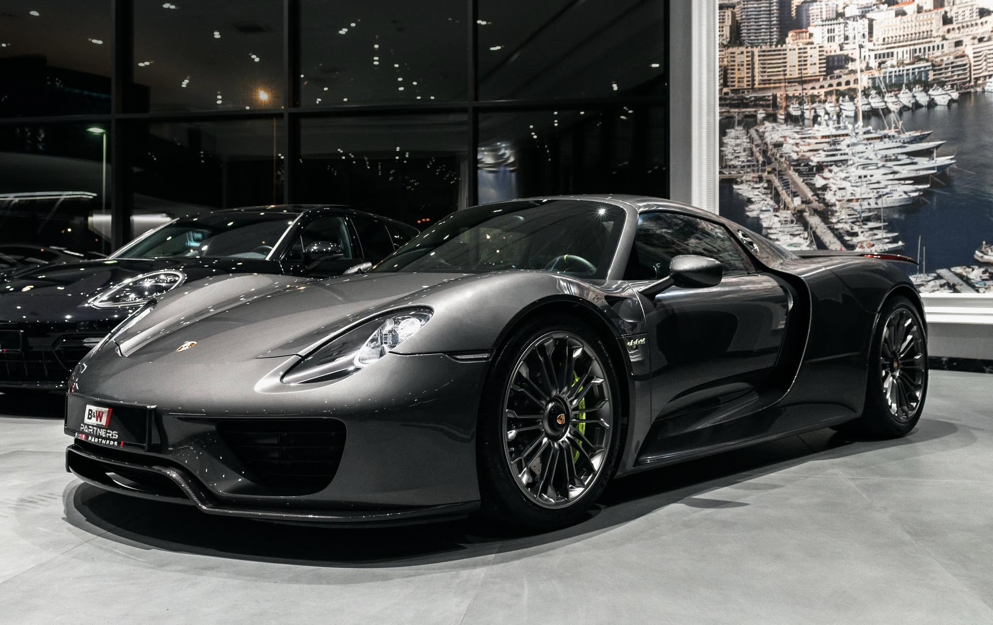 Silver Porsche with light reflected across its sculpted bodywork